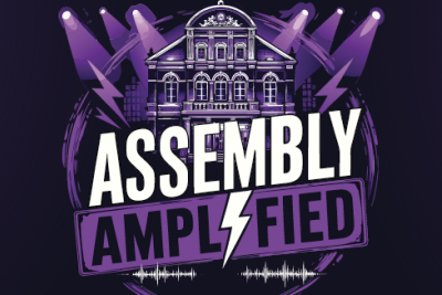 black poster with purple and assembly amplified writing 